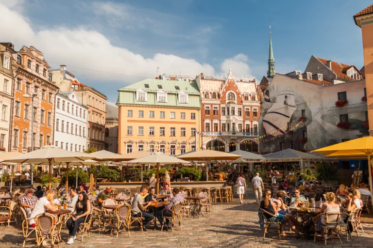 People sitting in street cafes in the old town of Riga.